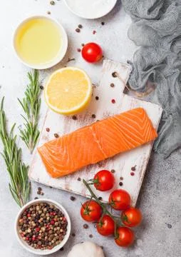 Plastic container with fresh salmon slice with oil tomatoes and lemon Foto stock