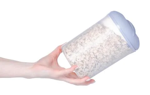 Plastic container of oatmeal in hand Stock Photos