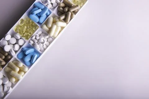 Plastic container with pills on white background Stock Photos
