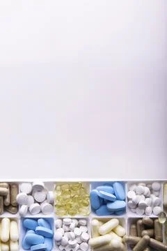 Plastic container with pills on white background Stock Photos