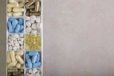 Plastic container with pills on white background Stock Photos