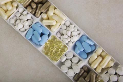 Plastic container with pills on white background Stock Photos