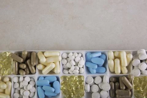 Plastic container with pills on white background Stock Photos