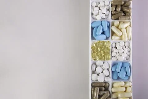 Plastic container with pills on white background Stock Photos
