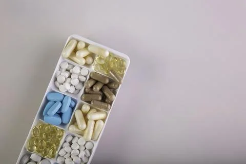 Plastic container with pills on white background Stock Photos