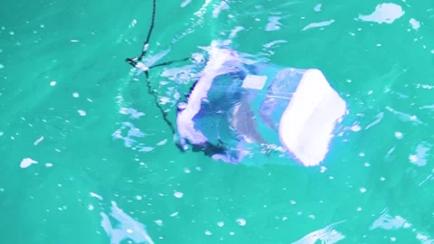 Plastic container in seawater Stock Footage 344891648