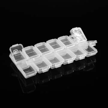 Plastic container for tablets on a black background. Stock Photos