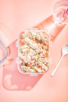 Plastic container to take away with Russian salad with a disposable plastic g Stock Photos