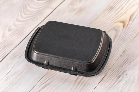 Plastic container on wood background. Closed food tray with lid Stock Photos