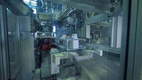 Plastic containers are getting filled in... | Stock Video | Pond5