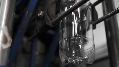 Plastic containers, bottles, go sequentially row along production conveyor line Stock Footage 161821896