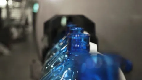 Plastic containers, bottles, go sequentially row along production conveyor line Stock Footage 161823356