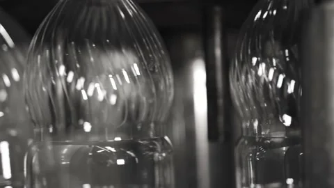 Plastic containers, bottles, go sequentially row along production conveyor line Stock Footage 161824364