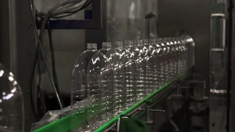 Plastic containers, bottles, go sequentially row along production conveyor line Stock Footage 161827348