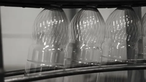 Plastic containers, bottles, go sequentially row along production conveyor line Stock Footage 161827438