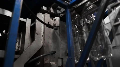 Plastic containers, bottles, go sequentially row along production conveyor line Stock Footage 161831001
