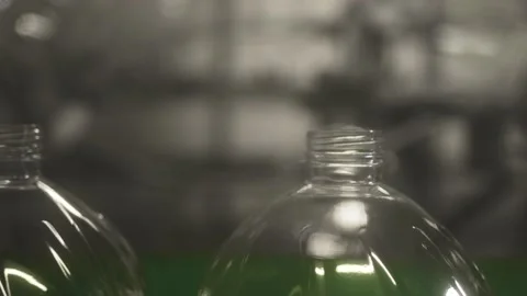 Plastic containers, bottles, go sequentially row along production conveyor line Stock Footage 161831841