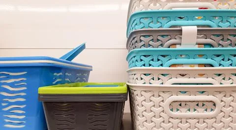 Plastic containers of different colors and prices are placed in a warehouse o 写真素材