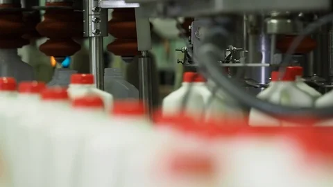 Plastic containers. Filled and sealed in bottling plant assembly line Stock Footage 101976105