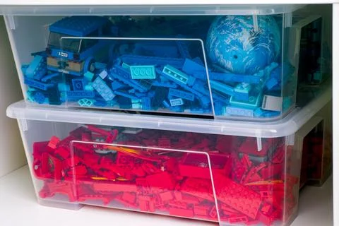 Plastic containers full of red and blue Lego blocks, bricks and toys in a cup Stock Photos