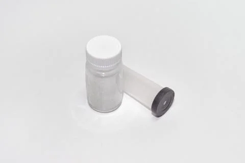 Plastic containers: jar for the tablets with screw cap and a test tube with b Stock Photos