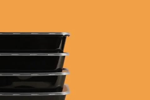 Plastic containers on orange background Stock Photos
