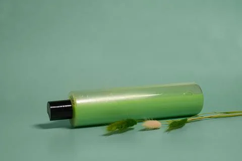 Plastic containers with shampoo and lagurus flowers Stock Photos