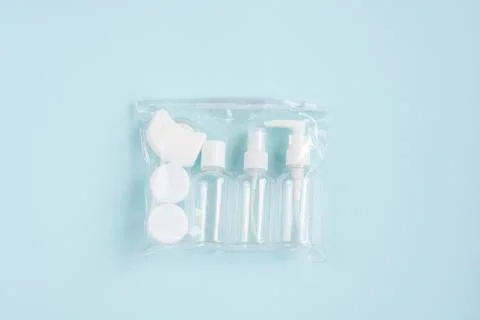 Plastic containers. Travel set on a blue background.  Plastic bottles for cre Stock Photos