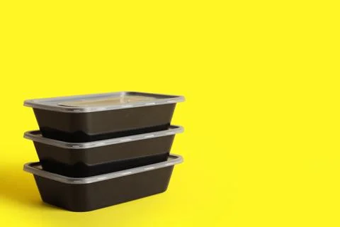 Plastic containers on yellow background Stock Photos