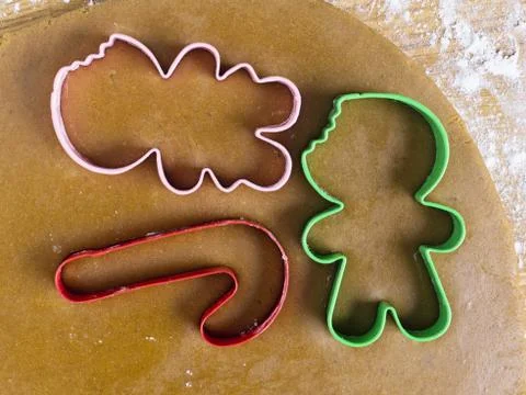 Plastic cookie cutters on dough Stock Photos
