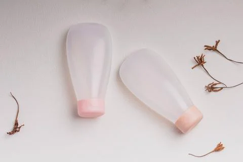 Plastic cosmetic bottle on light background.Face and body skin care with mari Stock Photos