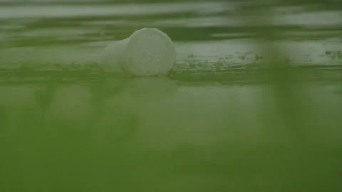 Plastic cup afloat on the water surface Stock Footage 254190869