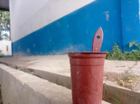 A plastic cup and a brush used as a brown paint container Stock Photos