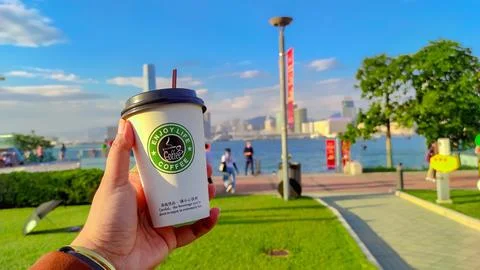 Plastic cup "Enjoy live coffee" Stock Photos