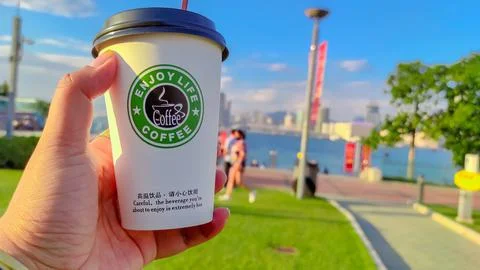Plastic cup "Enjoy live coffee" Stock Photos
