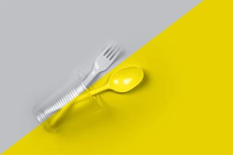 Plastic cup, fork, spoon on color 2021 Stock Photos