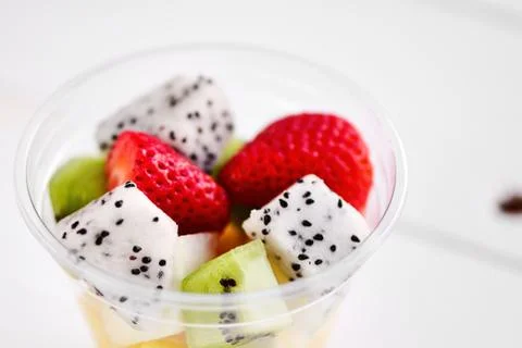 Plastic Cup with fruit, on white background Stock Photos