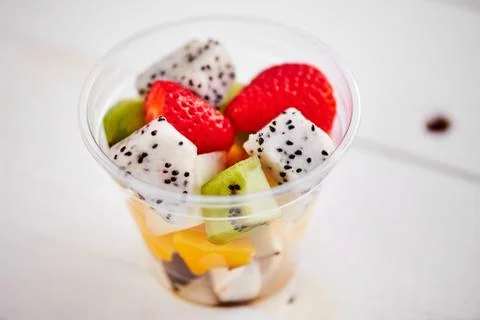 Plastic Cup with fruit, on white background Stock Photos