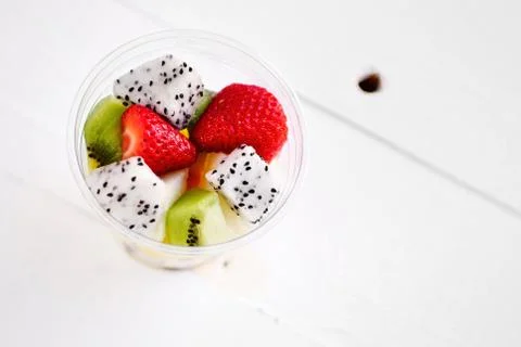 Plastic Cup with fruit, on white background Stock Photos