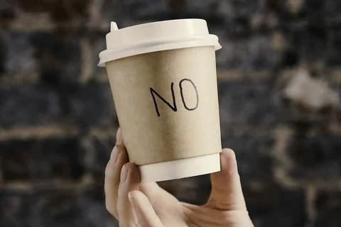 A plastic cup labeled NO. plastic cup with a lid. Protest habits Stock Photos