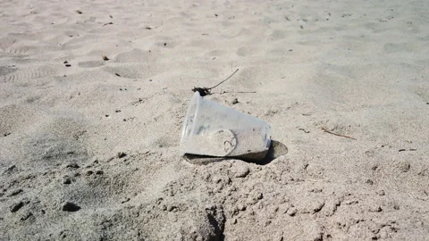 Plastic cup on the sand. Trash concept Stock Footage 186845453