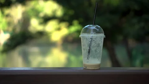 Plastic cup standing on the railing of the bridge against the backdrop of the Stock Footage 140112509