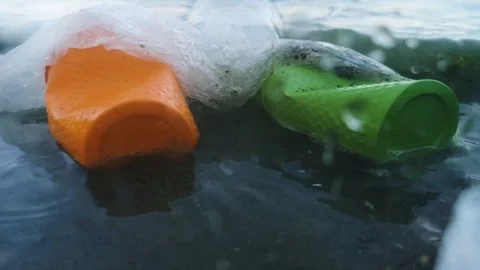 Plastic cups and tubes in the bottle. Live macro photography plastic. Perspectiv Stock Footage 111645417