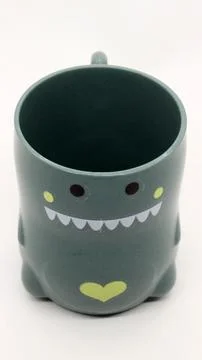 Plastic cups for children's drinking shaped like dinosaurs Stock Photos