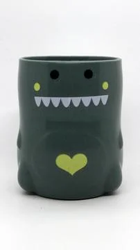 Plastic cups for children's drinking shaped like dinosaurs Stock Photos
