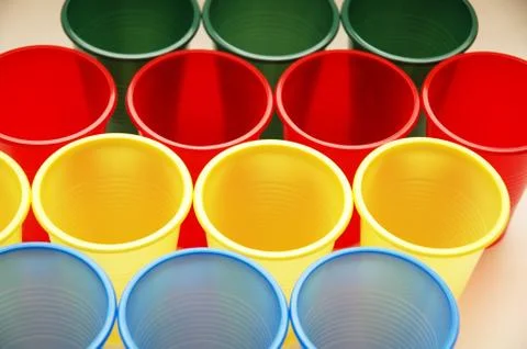 Plastic cups of various colours in rows Stock Photos