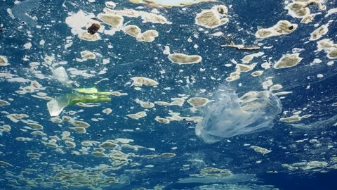 Plastic debris drifts on surface of polluted water, Slow motion Stock Footage 247248332