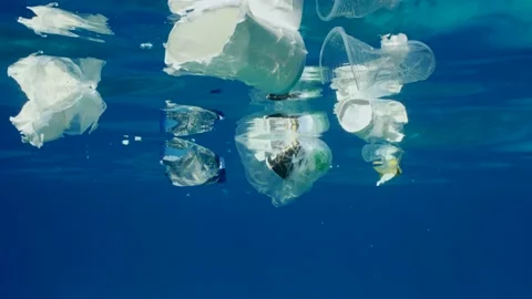 Plastic debris drifts under surface of Ocean, Slow motion Stock Footage 236194962