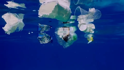 Plastic debris drifts under surface of Ocean, Slow motion Stock Footage 246038537