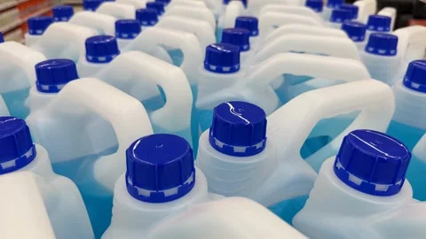 Plastic detergent bottles with blue caps, viewed from above, creating a rep.. Stock Footage 320053300